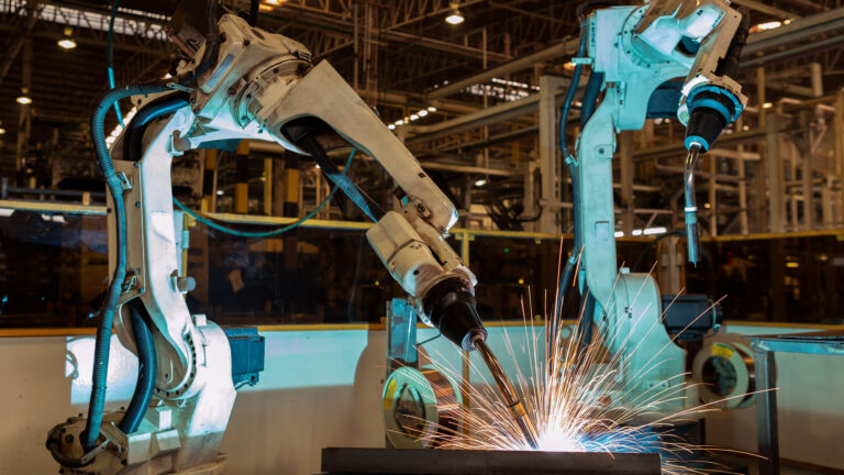 Robots are welding in car factory